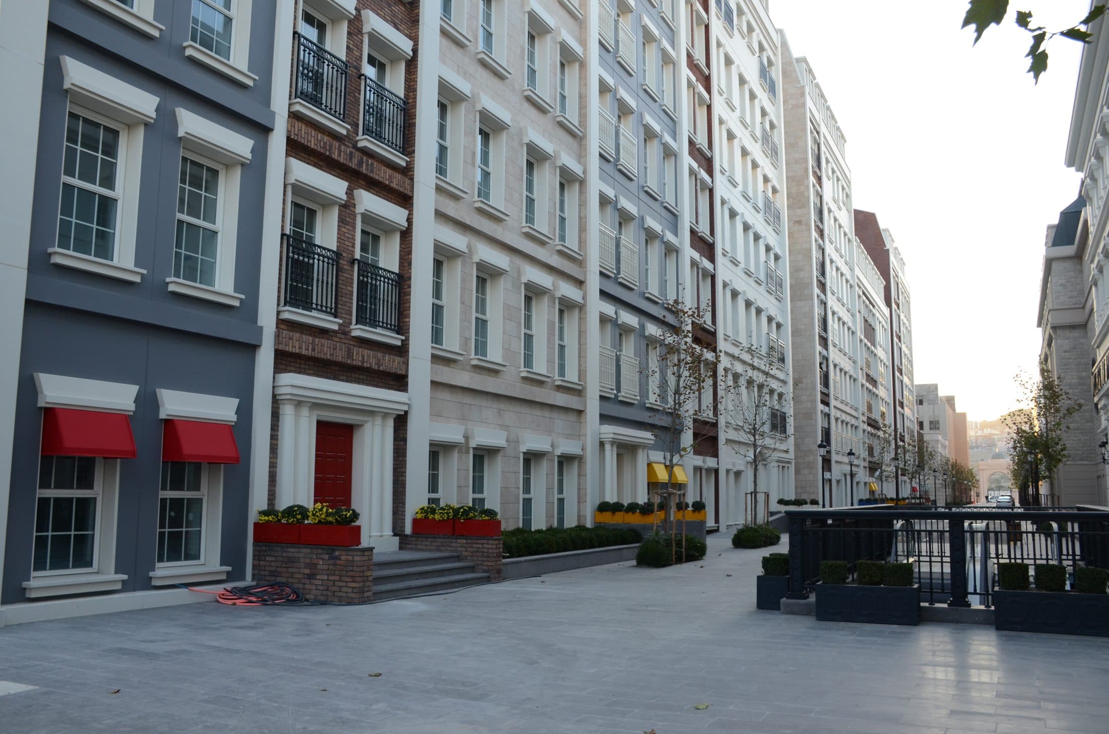 A campus street of differing facades, with no people in view.
