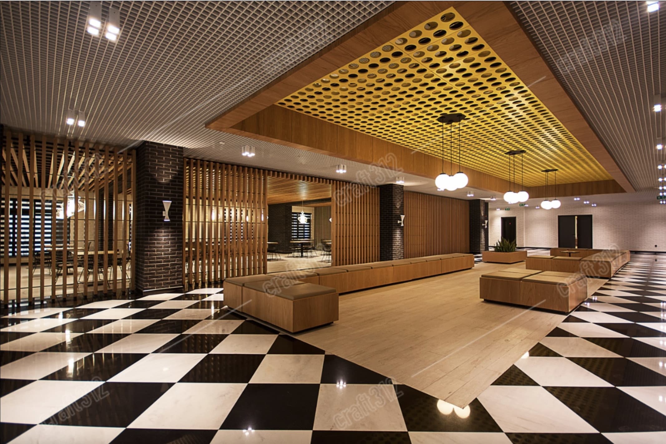 An interior lobby with a black-and-white checkered floor and wooden benches.